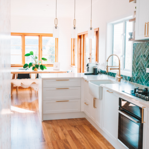 White cabinets with trendy gold drawer pulls in Madison IN
